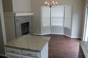 Raymore house for rent - A kitchen with a granite countertop and a fireplace.