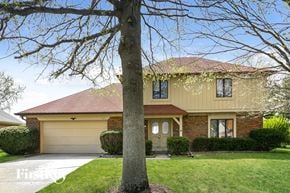 Noblesville house for rent - A house with a tree in front of it.