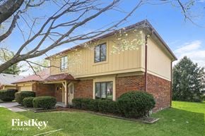 Noblesville house for rent - A house with a yellow exterior and a red roof is for sale by FirstKey Homes.