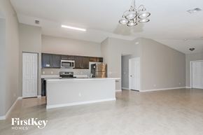 Port St. Lucie house for rent - an open kitchen and living room with a white counter top