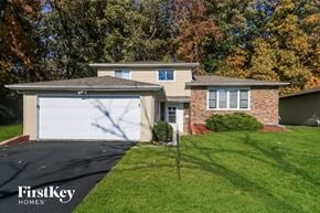 University Park house for rent - a home with a white garage door and a lawn
