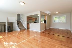 University Park house for rent - an empty living room with a hard wood floor and a staircase