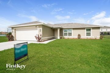 Cape Coral house for rent - a home with a lawn and a sign in front of it
