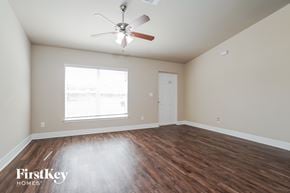 Cape Coral house for rent - a living room with hardwood floors and a ceiling fan