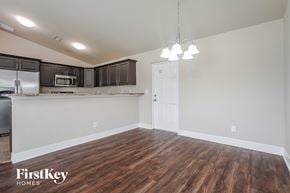 Cape Coral house for rent - the kitchen and living room of an empty house with wood flooring