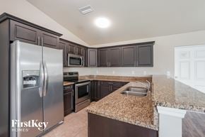 Cape Coral house for rent - a kitchen with granite counter tops and stainless steel appliances