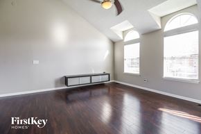 Raymore house for rent - the living room with hardwood flooring and large windows