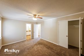 Birmingham house for rent - a master bedroom with carpet and a ceiling fan