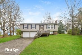 Greenwood house for rent - the front of a house with a lawn and a driveway