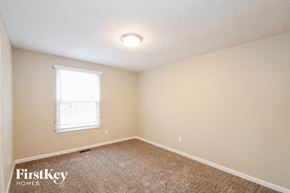 Greenwood house for rent - the bedroom of a house with carpet and a window