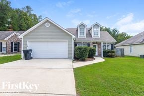 Calera house for rent - a home with a driveway and a garage door