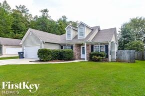 Calera house for rent - a small white house with a yard and a driveway