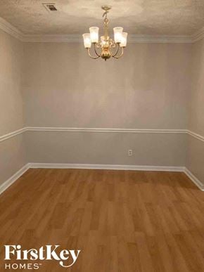 Jonesboro house for rent - A room with wooden flooring and a chandelier.