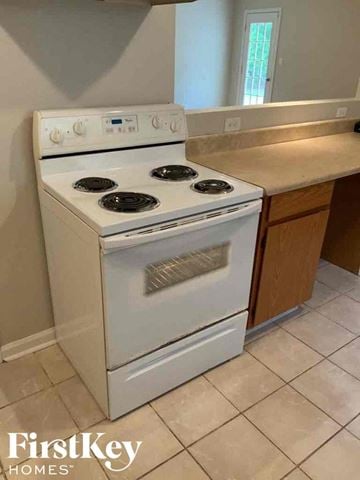 Jonesboro house for rent - A white stove in a kitchen with a tile floor.
