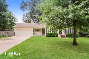 Collierville house for rent - a white house with a lawn and a tree