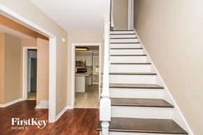 Collierville house for rent - a staircase leading up to a kitchen in a home with white stairs