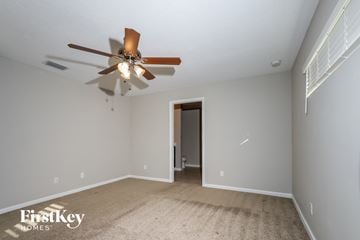 Port St. Lucie house for rent - a living room with a ceiling fan and a carpet