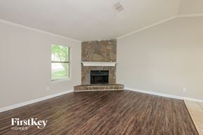 Lilburn house for rent - a living room with a fireplace and wooden floors