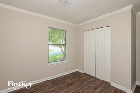 Lilburn house for rent - the bedroom of a home with a white door and a window
