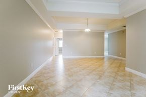 Homestead house for rent - A spacious room with tiled flooring and a single light fixture.