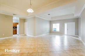 Homestead house for rent - A spacious empty room with a light hanging from the ceiling.