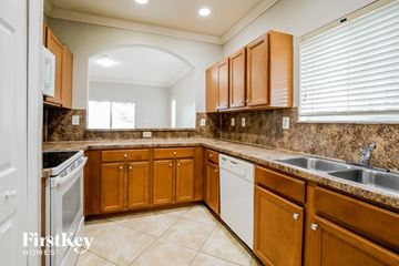 Homestead house for rent - A kitchen with brown cabinets and a white dishwasher.