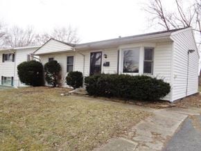 Wauconda house for rent - a white house with bushes in front of it
