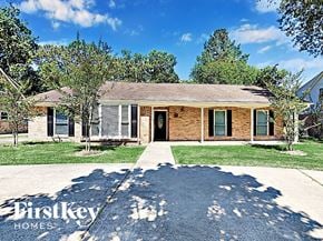 Conroe house for rent - an old brick house with a sidewalk and grass