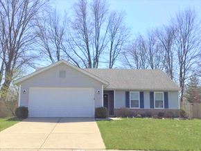 Cincinnati house for rent - a white house with a white garage door and a lawn