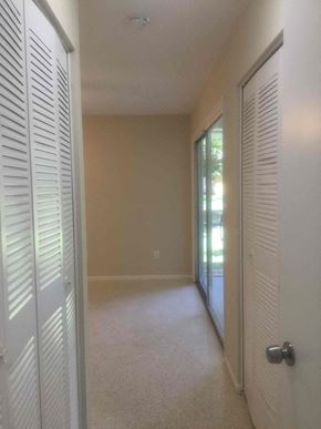 Port St. Lucie house for rent - a bedroom with a closet and a door to a patio