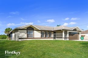 Naples house for rent - a home with a grassy yard and a house