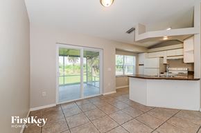 Naples house for rent - a kitchen with a sliding glass door leading to a patio