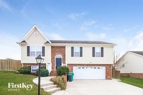 High Point house for rent - a white house with a white garage door in front of a lawn