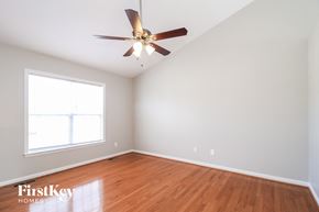 High Point house for rent - a bedroom with wood floors and a ceiling fan