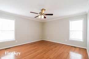 High Point house for rent - a living room with wood floors and a ceiling fan