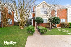 Memphis house for rent - A FirstKey Homes residential area with a building and a tree.