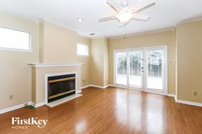Memphis house for rent - A spacious living room with a fireplace and sliding glass doors.