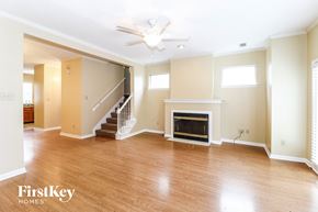 Memphis house for rent - A spacious living room with wood flooring and a fireplace.