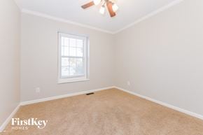 Raymore house for rent - a bedroom with a ceiling fan and a window