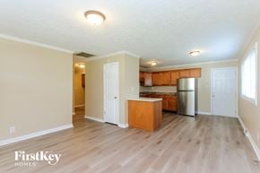 New Whiteland house for rent - A kitchen with wooden floors and a refrigerator.