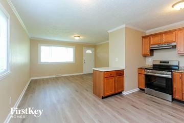 New Whiteland house for rent - A kitchen with wooden cabinets and a stainless steel oven.