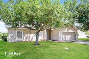 Kissimmee house for rent - a house with a tree in the front of it