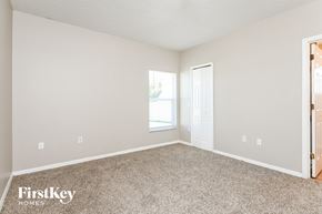 Kissimmee house for rent - a bedroom with carpet and a door to a window
