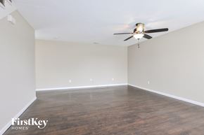Lake Saint Louis house for rent - A room with a ceiling fan and wooden flooring.