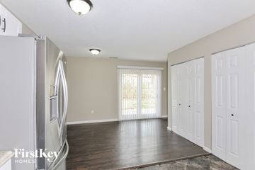 Lake Saint Louis house for rent - A kitchen with a refrigerator and a dining table.