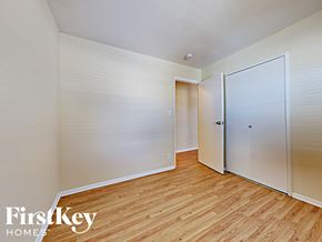 Streamwood house for rent - a bedroom with wood flooring and white closets