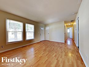Streamwood house for rent - an empty living room with wood flooring and windows