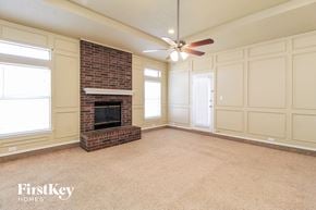 Arlington house for rent - a living room with a brick fireplace and a ceiling fan