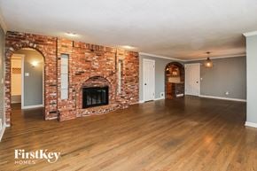 Kansas City house for rent - the living room of a house with a brick fireplace
