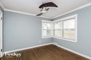 Kansas City house for rent - a bedroom with two windows and a ceiling fan